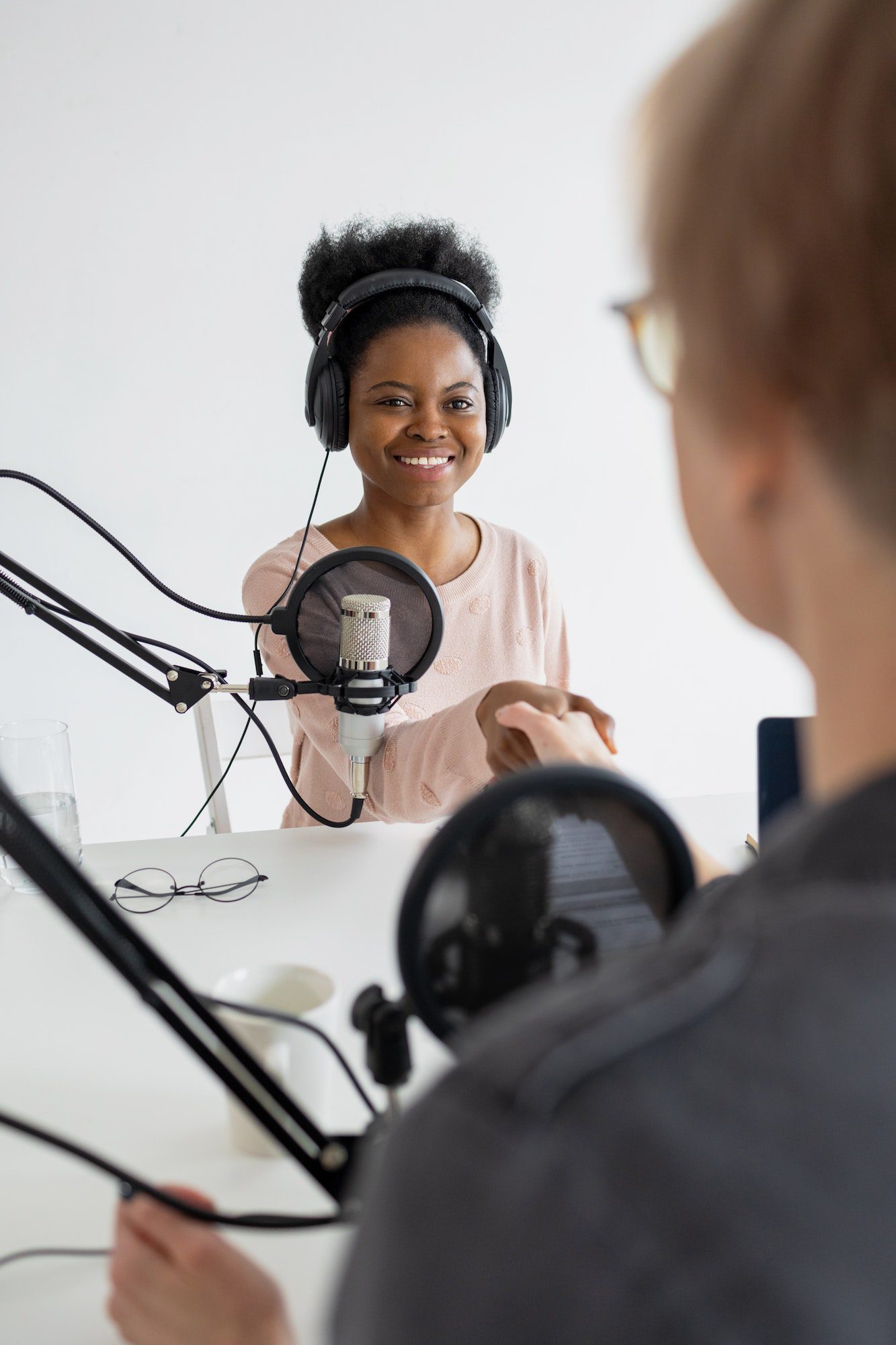 confident African American woman shaking hands with radio host